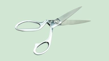 Scissor on green background